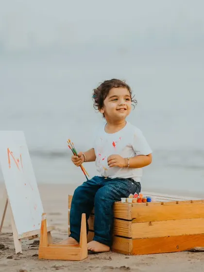 An artist at work. This outdoor painting session on the beach combines a creative activity with a beautiful natural backdrop.