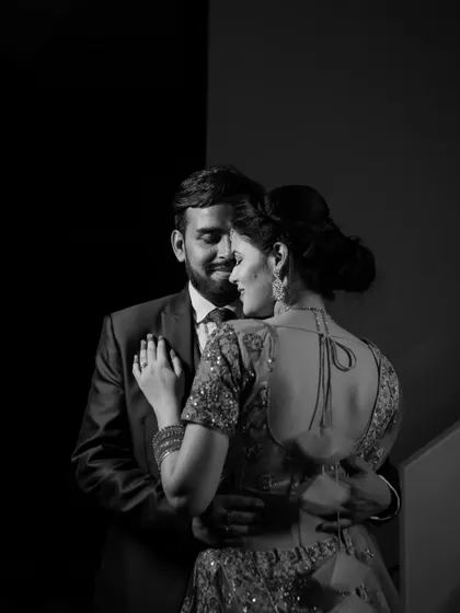 A timeless black and white portrait of Deepak and Deepa sharing a dance. This intimate shot focuses on their embrace and the emotion of the moment.