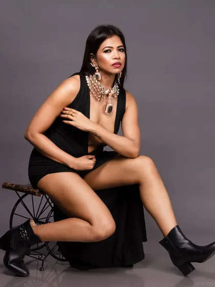 A full-body shot of the model in the black dress, showing her boots and a confident pose.