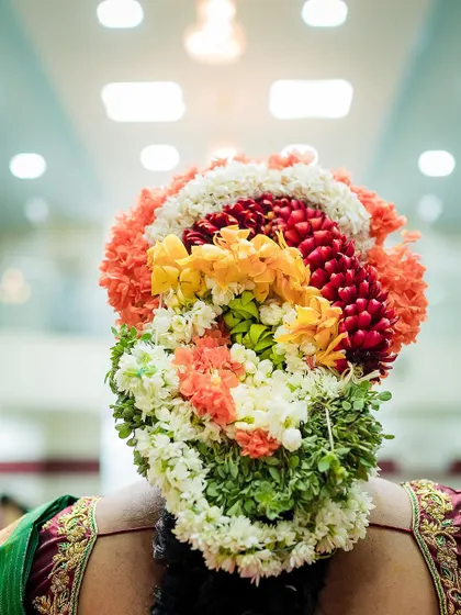 A detailed shot of the intricate floral hair arrangement, a traditional part of many South Indian ceremonies like this baby shower.