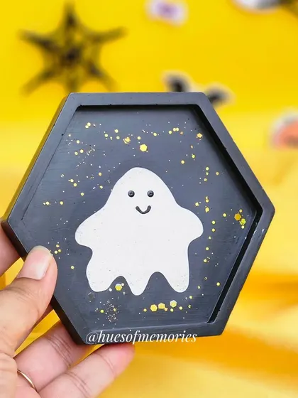 Holding the hexagonal ghosty trinket tray. The gold specks add a little bit of magic to the spooky design.