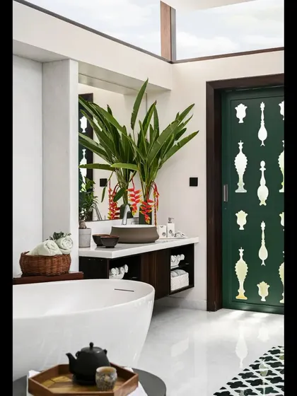 The design of this spa bathroom includes a custom-painted door with mother-of-pearl bottle motifs, adding a playful and artistic element. The skylight ensures the space is always bright and welcoming.