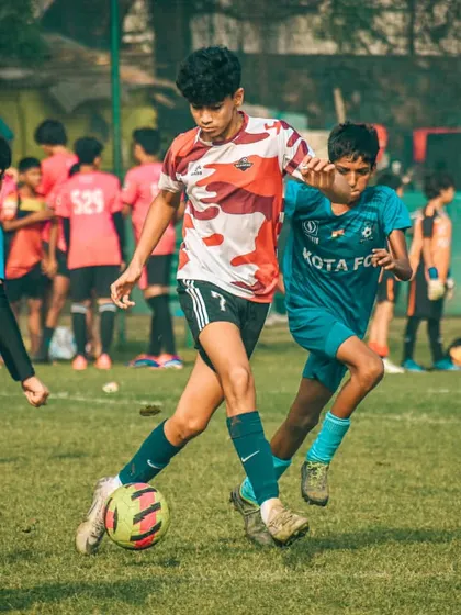 A player skillfully dribbles through traffic, showing composure under pressure.