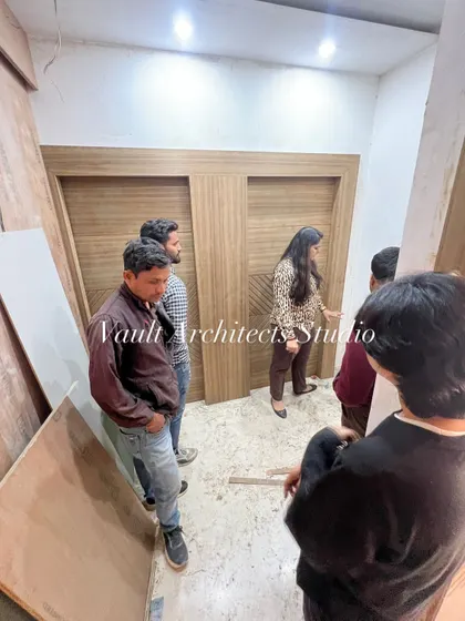 Exploring the interior details during a site visit. I am here with my team, discussing the woodwork and ensuring functionality in every corner.