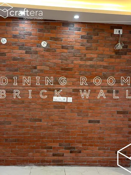 A dining room featuring a rustic brick accent wall. This adds texture and an industrial-chic vibe to the space, creating a warm and inviting atmosphere for meals.