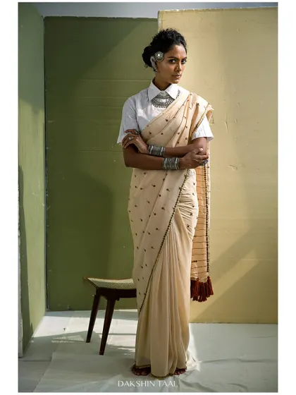 This portrait is a blend of modern styling and traditional grace. The natural light and earthy tones complement the beautiful saree, resulting in an editorial shot that feels both powerful and effortlessly elegant.