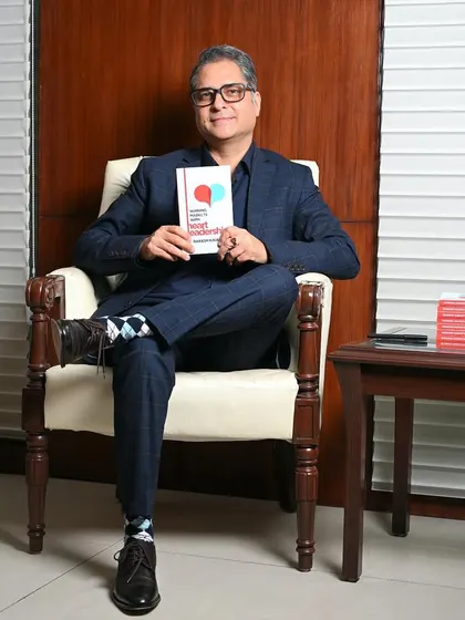 A full-length seated portrait of the author. This more formal shot is great for feature articles or an official author website.