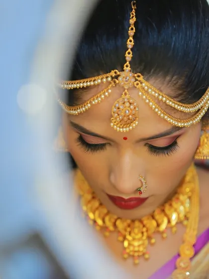 An artistic shot of a bride looking into a mirror, creating a soft and dreamy portrait.