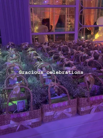 The return favor baskets displayed at the first birthday party venue. We coordinated the colors and fresh flower decorations to match the party's decor perfectly.