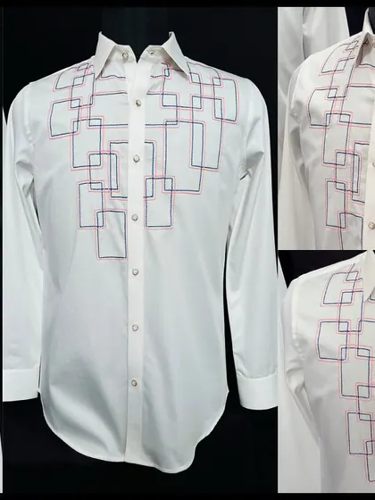 A detailed look at the white shirt with an embroidered grid of intersecting red and blue squares. It's a piece that is both structured and artistic.