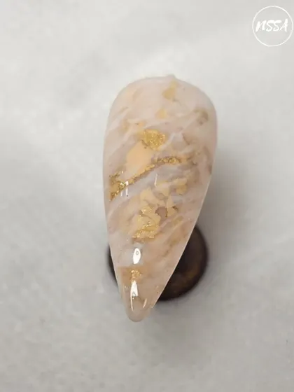 This marble nail with gold leaf flakes was created by a student. They did a wonderful job of creating a soft, natural stone effect.