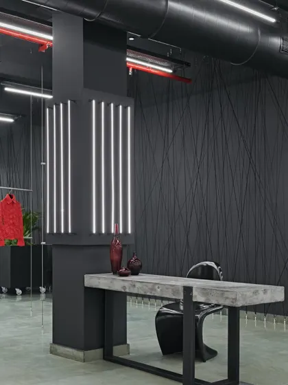 In a waiting area for a secret Italian fashion design house, we blended industrial chic with timeless sophistication. The black and red hues create a striking contrast, echoing the raw beauty of industrial elements and the craftsmanship of couture.