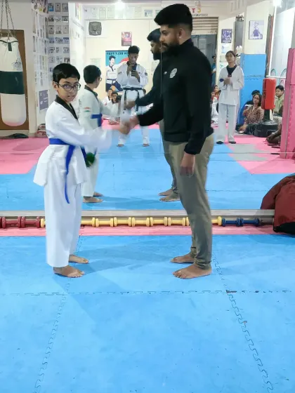 A handshake for a student who has earned his new belt.