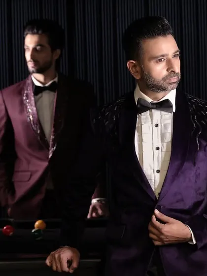 This image captures the rich texture and color of our purple and maroon velvet tuxedos. These pieces are designed for high-impact formal events, offering a luxurious alternative to conventional evening wear.