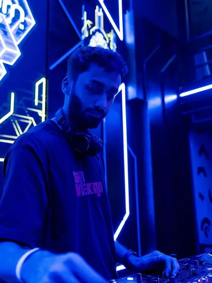 A moody, blue-lit portrait of me focused on the music.