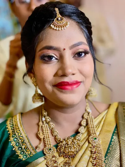 A close-up from a Seemantham (baby shower) ceremony. I created a vibrant look with shimmery eyeshadow and a bold red lip to match the festive occasion and her traditional silk saree.