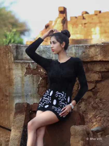 A thoughtful pose in a rustic outdoor setting. The natural light and earthy tones create a calm and contemplative mood.