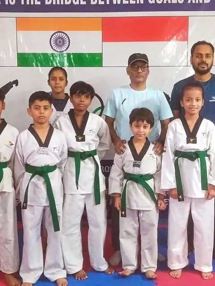 Our newly promoted green belts with their coaches. The green belt signifies a deeper understanding of Taekwondo fundamentals.