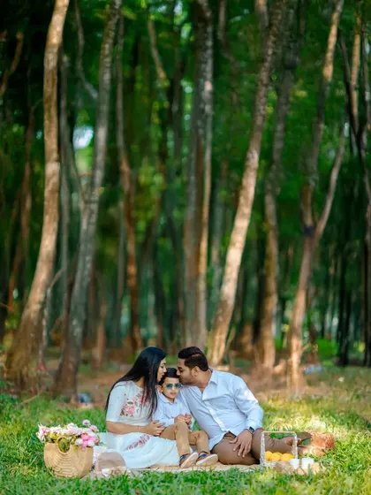 In the middle of a forest clearing, we captured this intimate family moment. The father's gentle kiss and the mother's loving gaze create a powerful image of the close bonds we aim to highlight in our family photography.