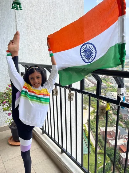 A gymnast's creative take on Independence Day, holding the flag with pride while showcasing her incredible flexibility.