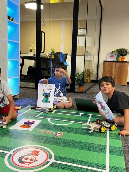 Another great shot of my students with their creations on the robot soccer field. They have worked hard to design, build, and test their robots for the competition.