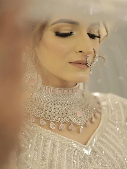 A dreamy, through-the-veil shot that focuses on the soft, shimmery eye makeup. This look is perfect for a bride who wants to feel like a princess on her wedding day.