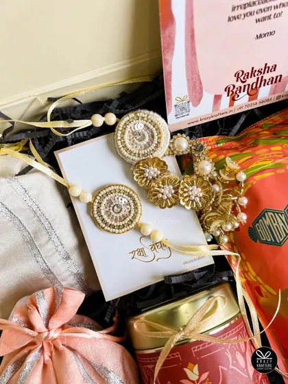 A close-up of the exquisite handcrafted bhaiya-bhabhi rakhi set from our 'Laad Pyaar' hamper.
