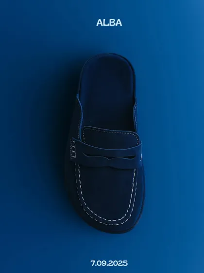 Announcing the Alba mule in a deep, versatile navy. This product shot captures the clean lines and classic loafer-inspired design of the shoe, a perfect staple for any wardrobe.