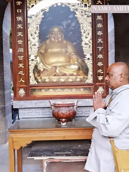 Praying before a statue in the monastery. These places of worship are central to the practice of Chan (Zen) meditation and cultivating a peaceful mind.