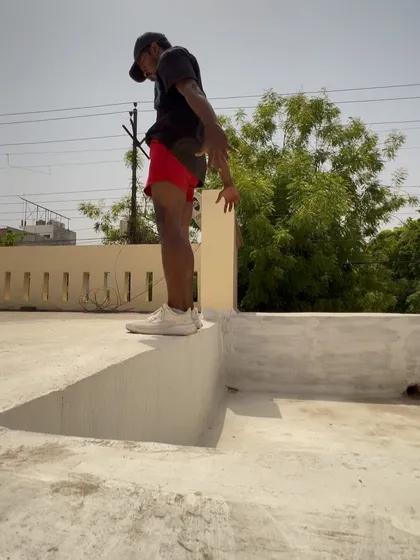 Preparing for a box jump on a ledge during a vacation workout.