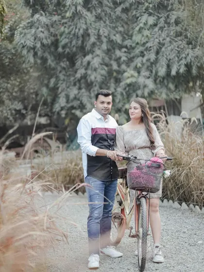 A casual moment captured in our natural outdoor area. The vintage bicycle prop adds a touch of whimsy to this sweet couple's portrait.