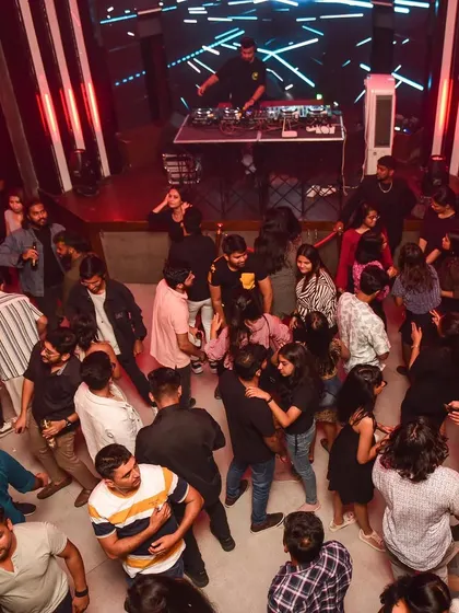 An overhead view of the dance floor, showing a crowd completely in sync, dancing to the beat. This is the unity I aim for.