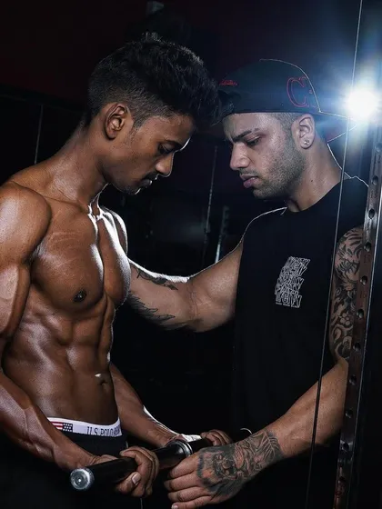 A moment of intense focus during a workout. My role is to push my clients beyond their limits while ensuring their technique is flawless.