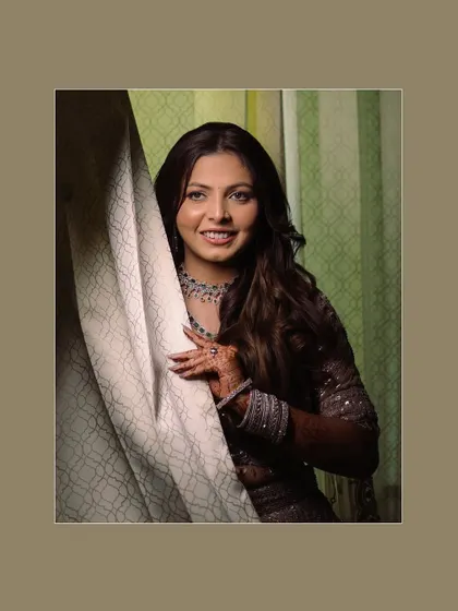 A classic bridal portrait, where the bride peeks out from behind a curtain, creating a soft and gentle look.