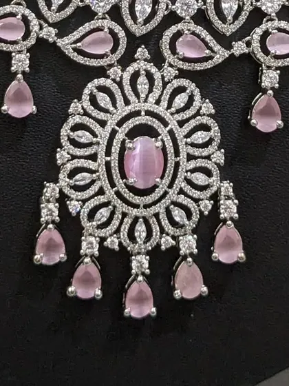 A close-up of the pendant on the pastel pink AD set, showing the beautiful cat's-eye stone and intricate detailing.