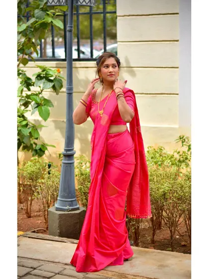 Our client looking stylish and confident in her custom pink saree. It's perfect for a festive occasion or a party.