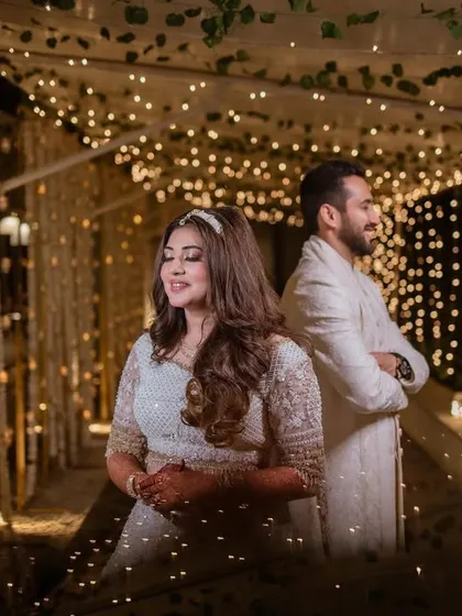 A creative shot of the couple in a tunnel of lights. We use dramatic lighting to create magical and memorable wedding portraits.