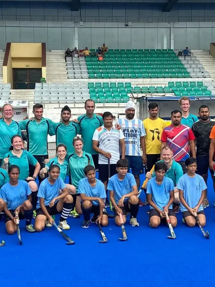 A large group photo with both teams after a close and exciting game. We believe in fostering positive relationships with our opponents.