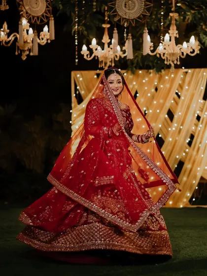 A beautiful twirling shot of the bride, Tanvi, in her stunning red wedding lehenga.