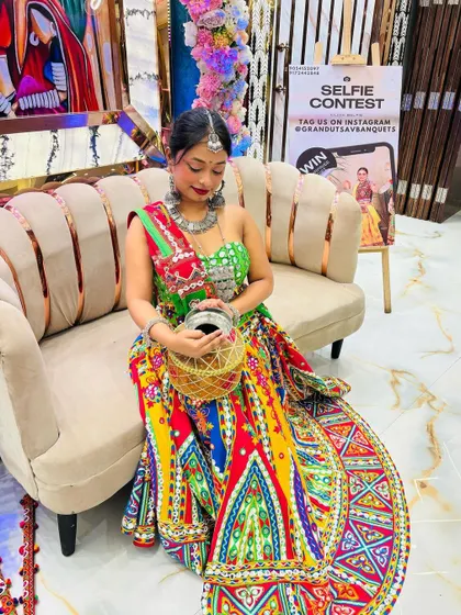 A beautiful multi-colored lehenga with a vibrant green blouse. The look is completed with a traditional silver potli, perfect for keeping your essentials safe while you dance.