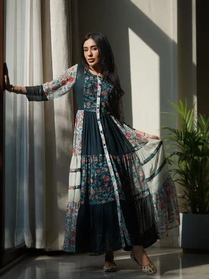 A slightly different angle of the patchwork dress, showing how the model interacts with the environment to create a natural, lifestyle feel for the clothing brand.