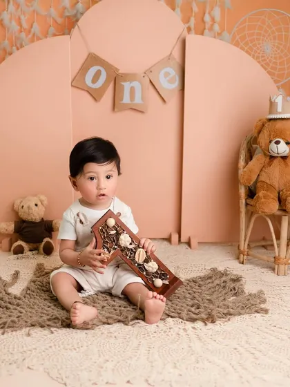 Our darling boy celebrating his first milestone with us. The earthy tones and natural props in this setup create a calm and beautiful atmosphere for a first birthday session.