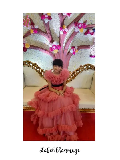 I designed this onion pink frills gown for a young client. The off-shoulder neckline is made of soft, gathered tulle.