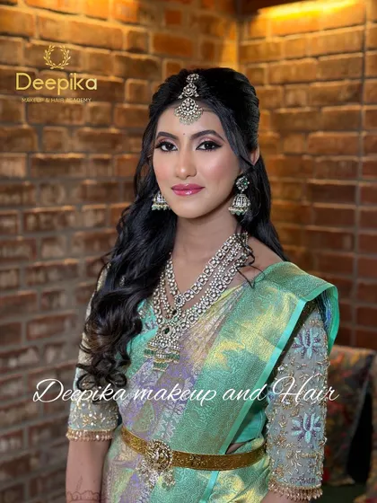A beautiful US bride ready for her reception in a light green gown with diamond jewelry.
