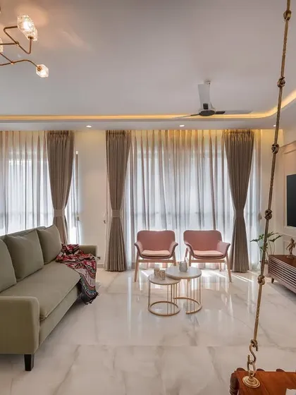 This living room captures our love for soft, pastel hues that create a lively and chic atmosphere. The traditional wooden swing adds a personal touch, blending modern furniture with timeless Indian elements to make the space feel like home.