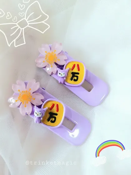 Inspired by Japanese kawaii culture, these purple hair clips feature cherry blossom and character charms. They are a unique and adorable accessory for anyone who loves pastel and anime aesthetics.