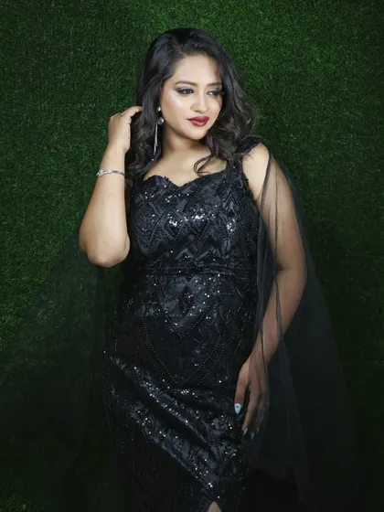 A closer look at the geometric sequin pattern on the black gown. It's a sophisticated detail that makes the dress stand out.