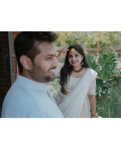 A sweet moment between the couple during their white-themed Haldi celebration.