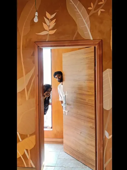 A fun, candid moment with the team peeking through the door after a long day of painting.