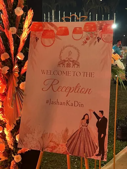 A personalized welcome sign for the reception, with a custom illustration of the couple. This adds a sweet, personal touch to the entrance decor.